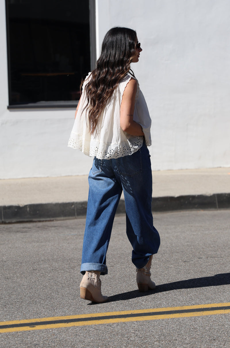 Person walking on a street next to a building
