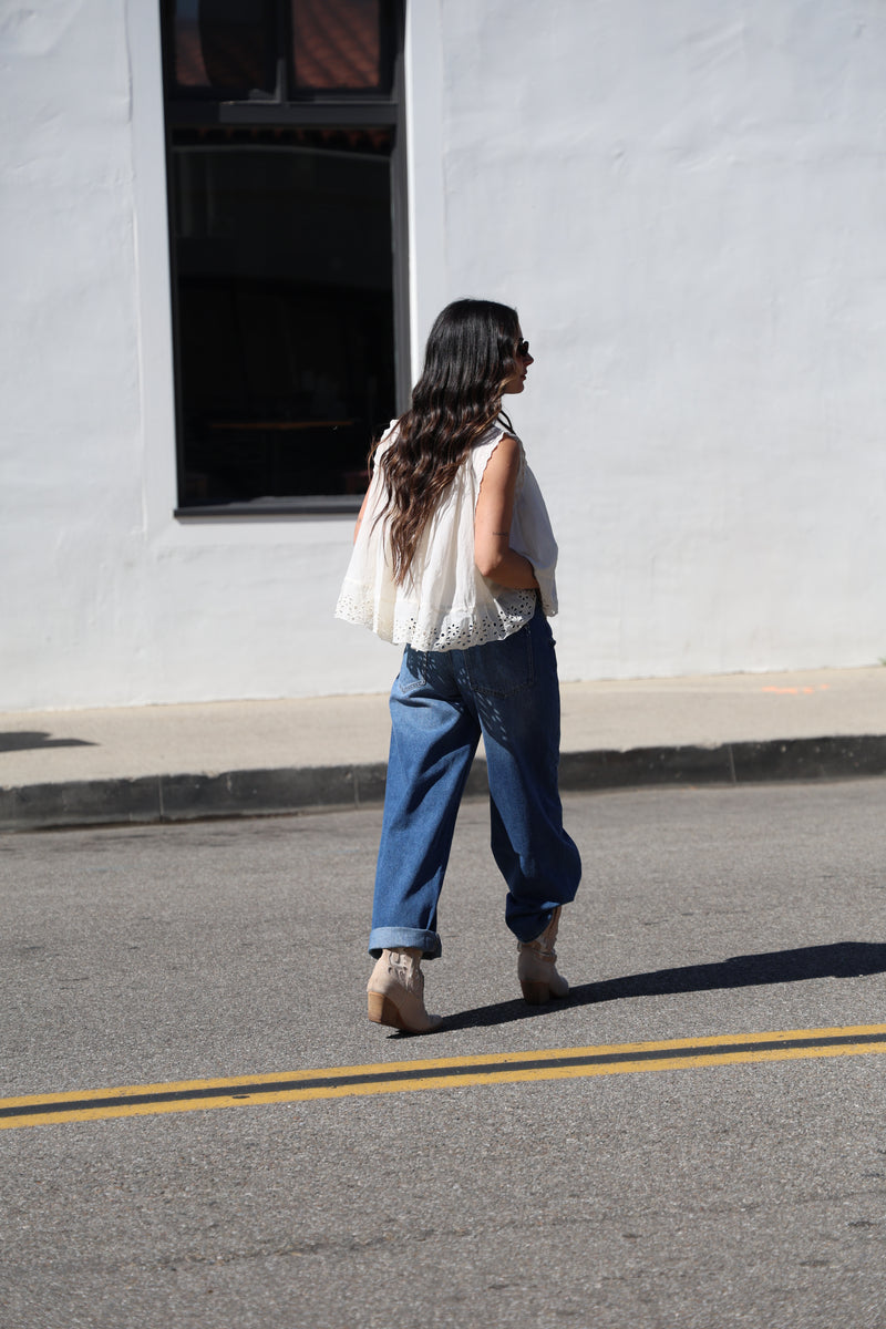 Person walking on a street next to a building