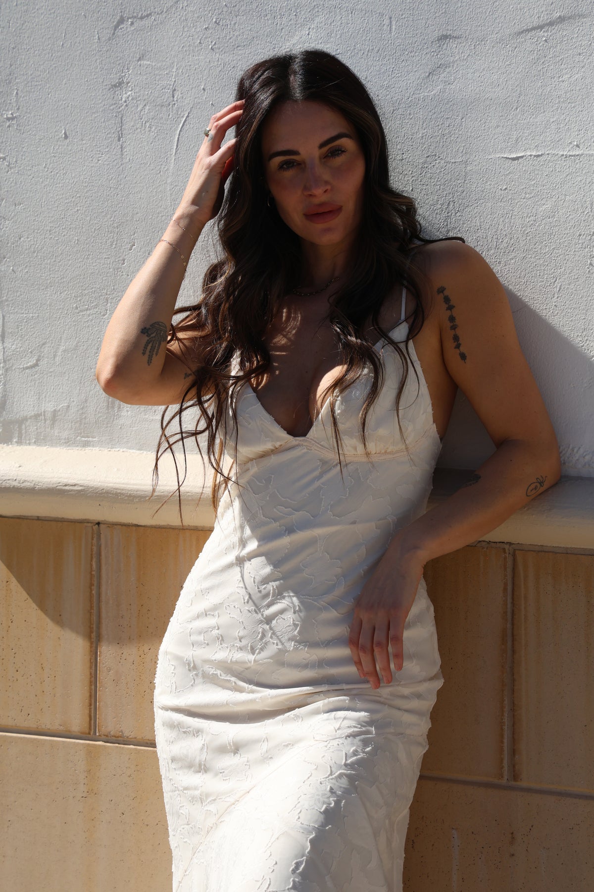 Woman lying on a textured surface with a neutral background