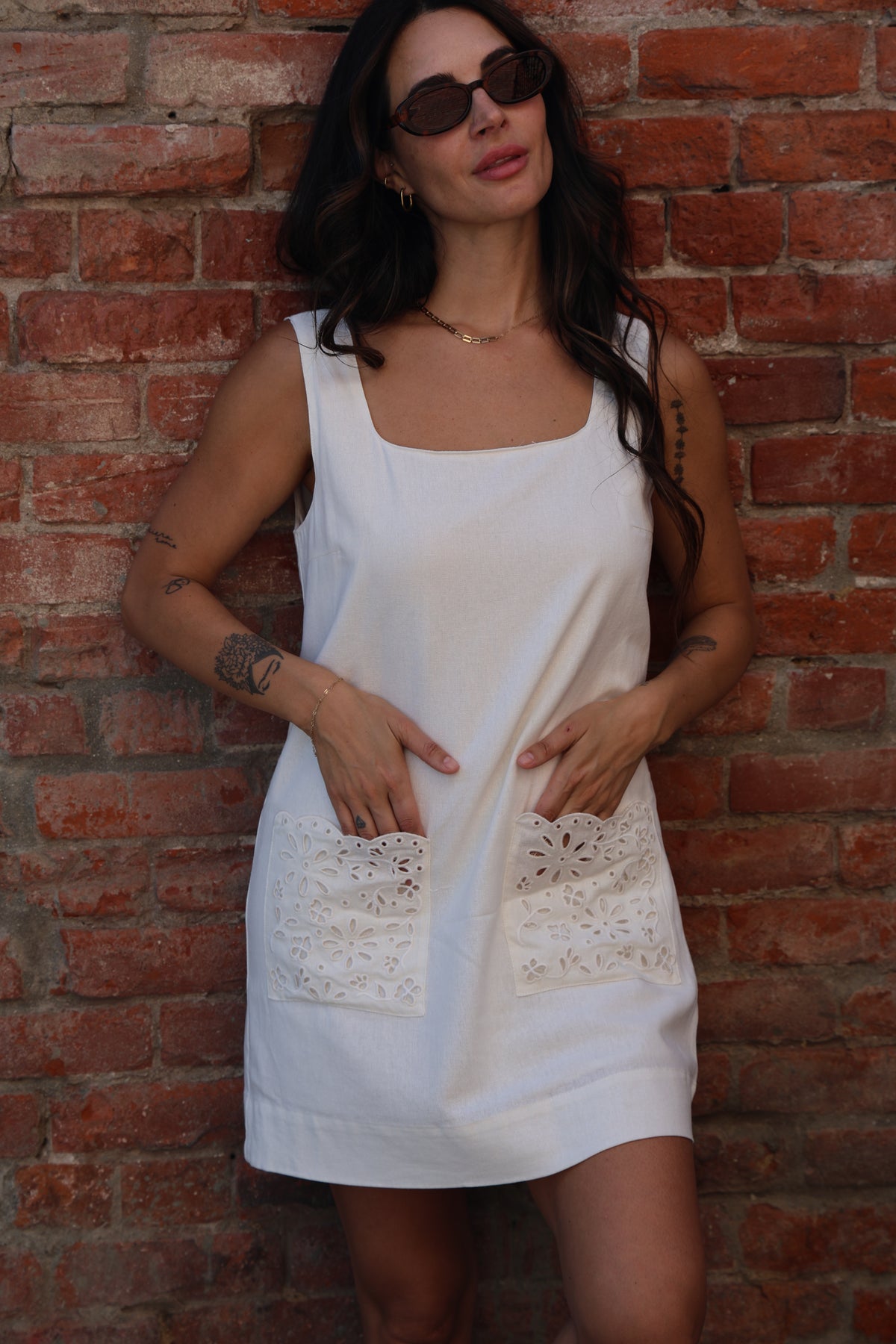 Woman in a white dress lying on a brick floor