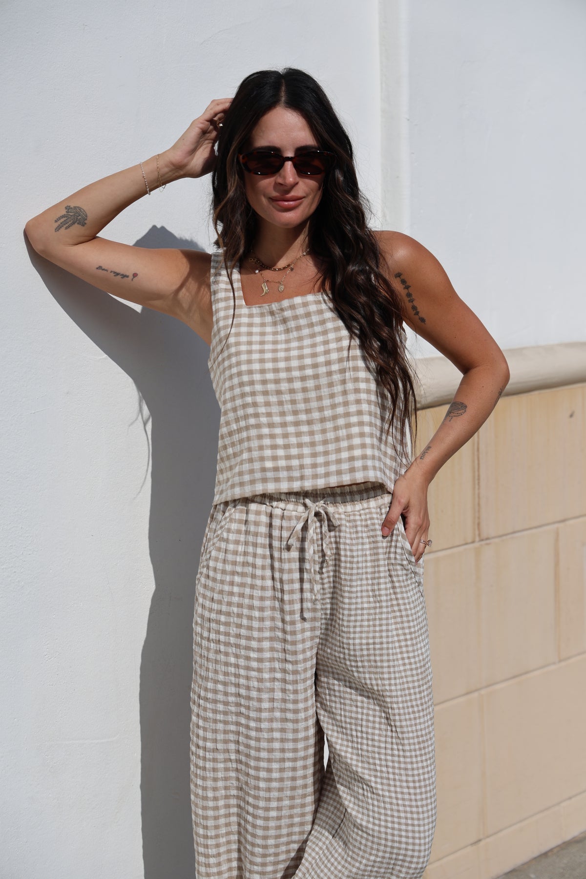 Woman wearing a checkered outfit with a white background
