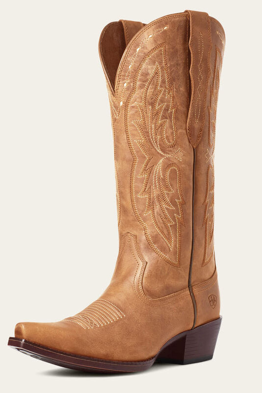 Brown cowboy boot with intricate embossing on a white background