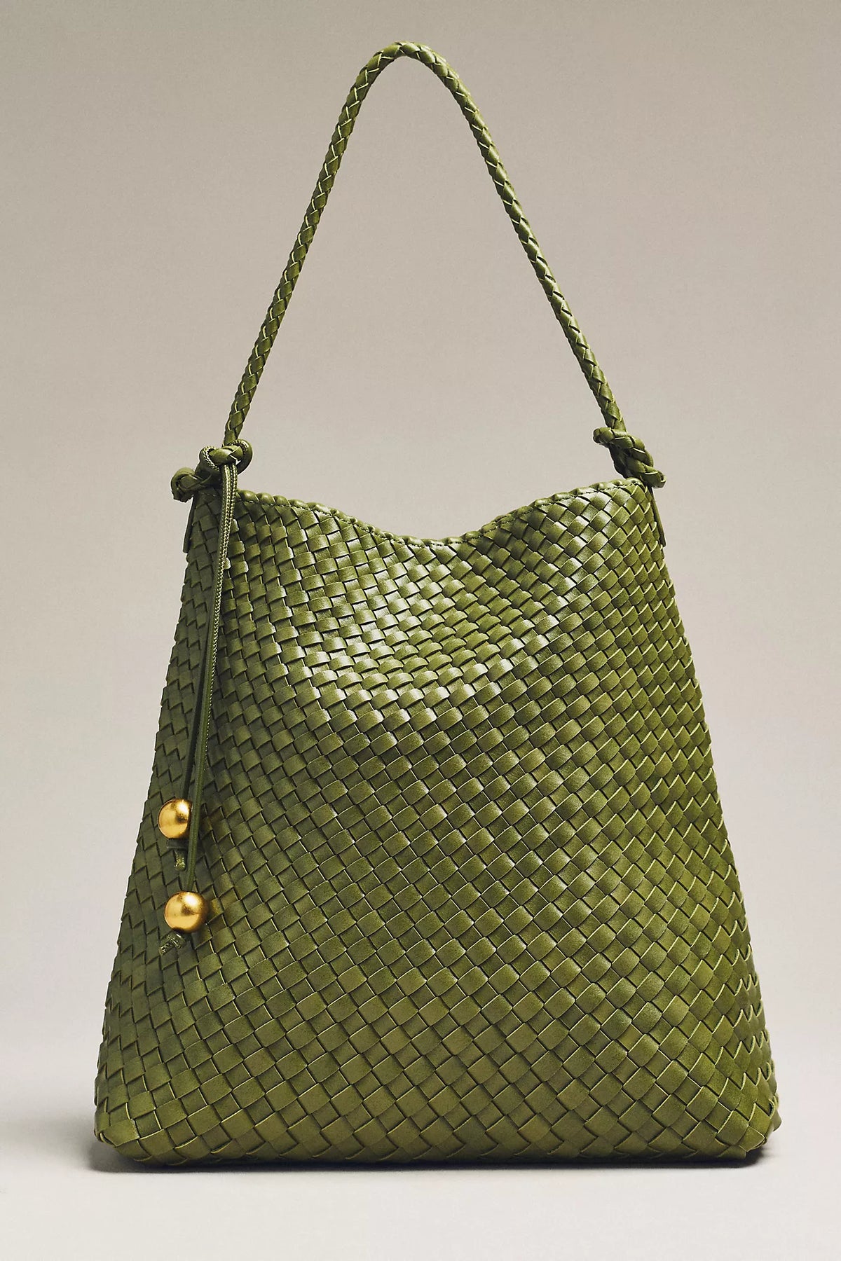 Green woven bag on a grey background