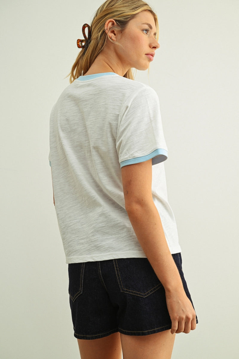 Woman modeling a white tee with a blue collar