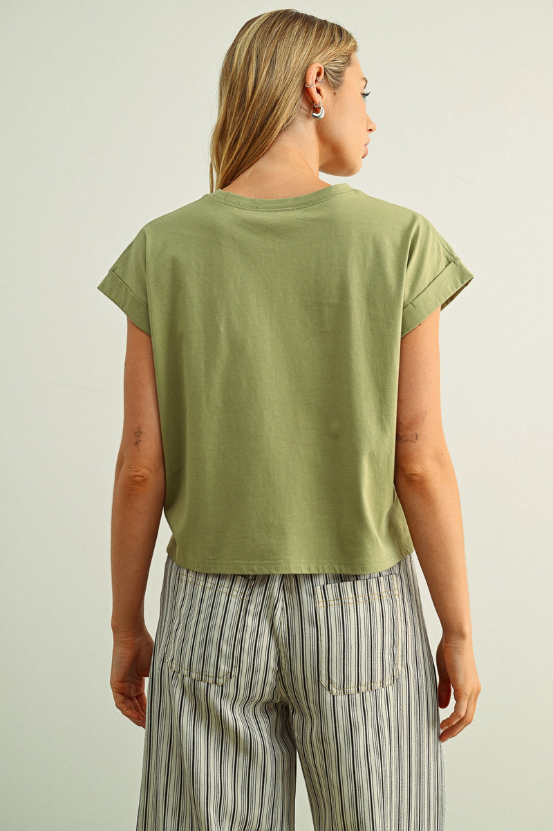 Person wearing a green t-shirt and striped pants on a plain background