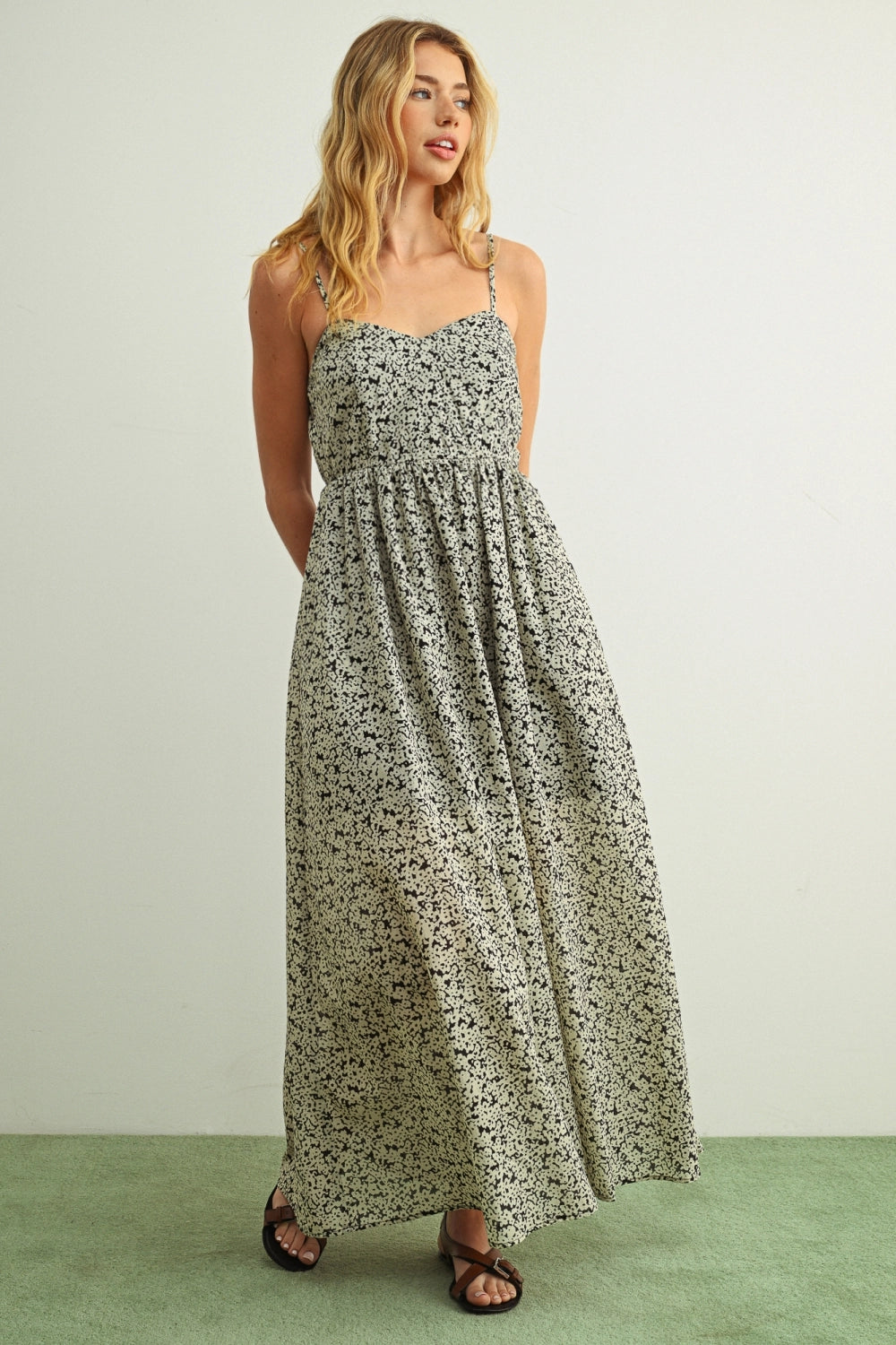 Woman wearing a floral dress on a plain background