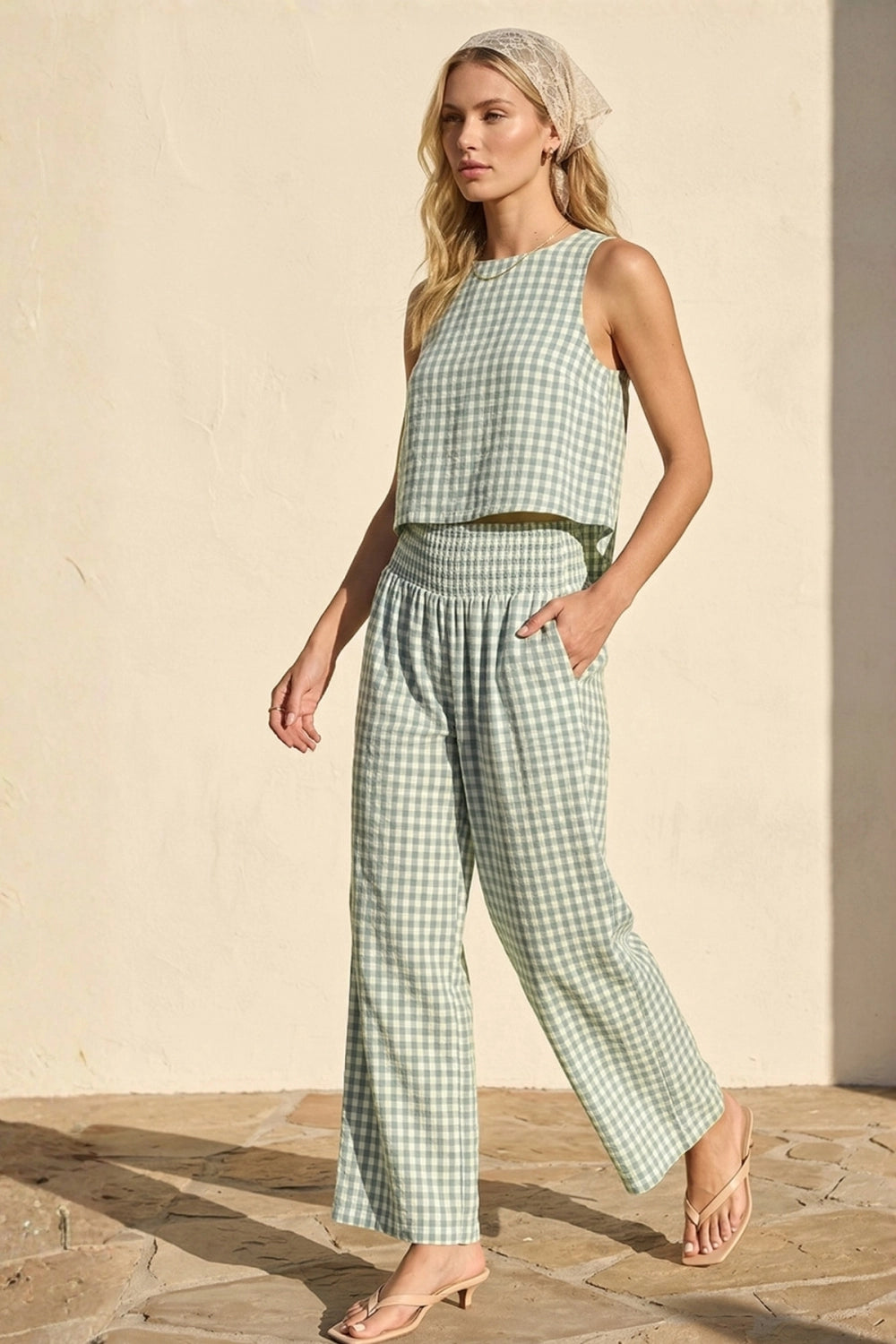 Woman wearing a green checkered outfit against a beige background