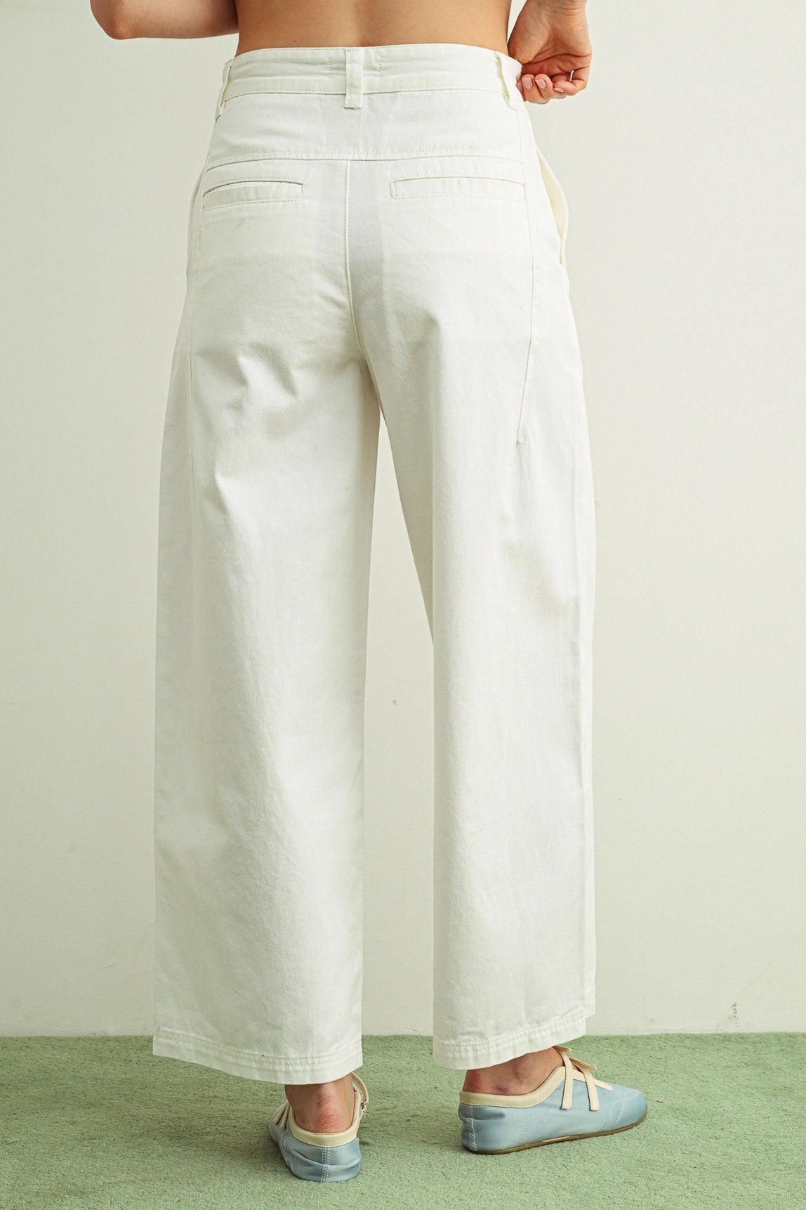 White wide-leg pants worn by a person on a plain background