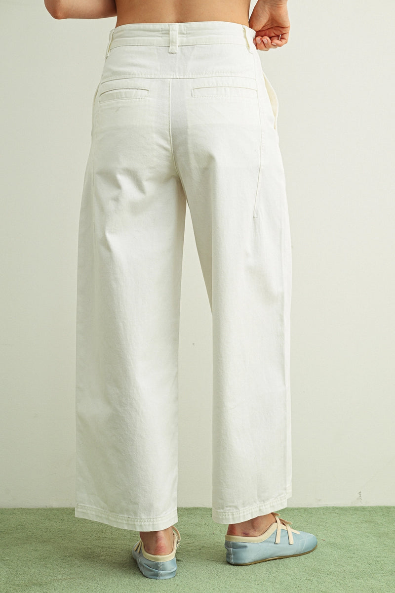 White wide-leg pants worn by a person on a plain background