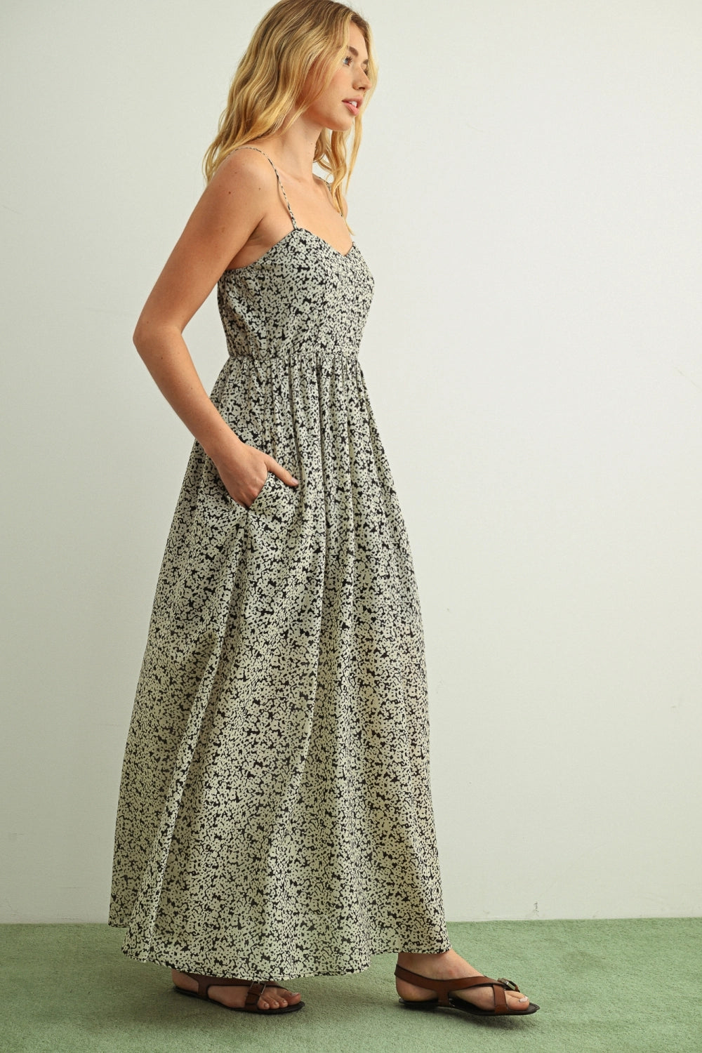 Woman wearing a floral dress against a plain background