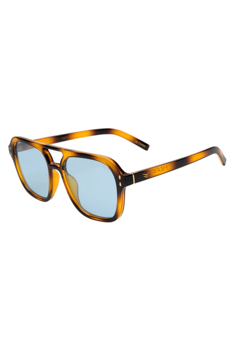 Sunglasses with tortoiseshell frame and blue lenses on a white background