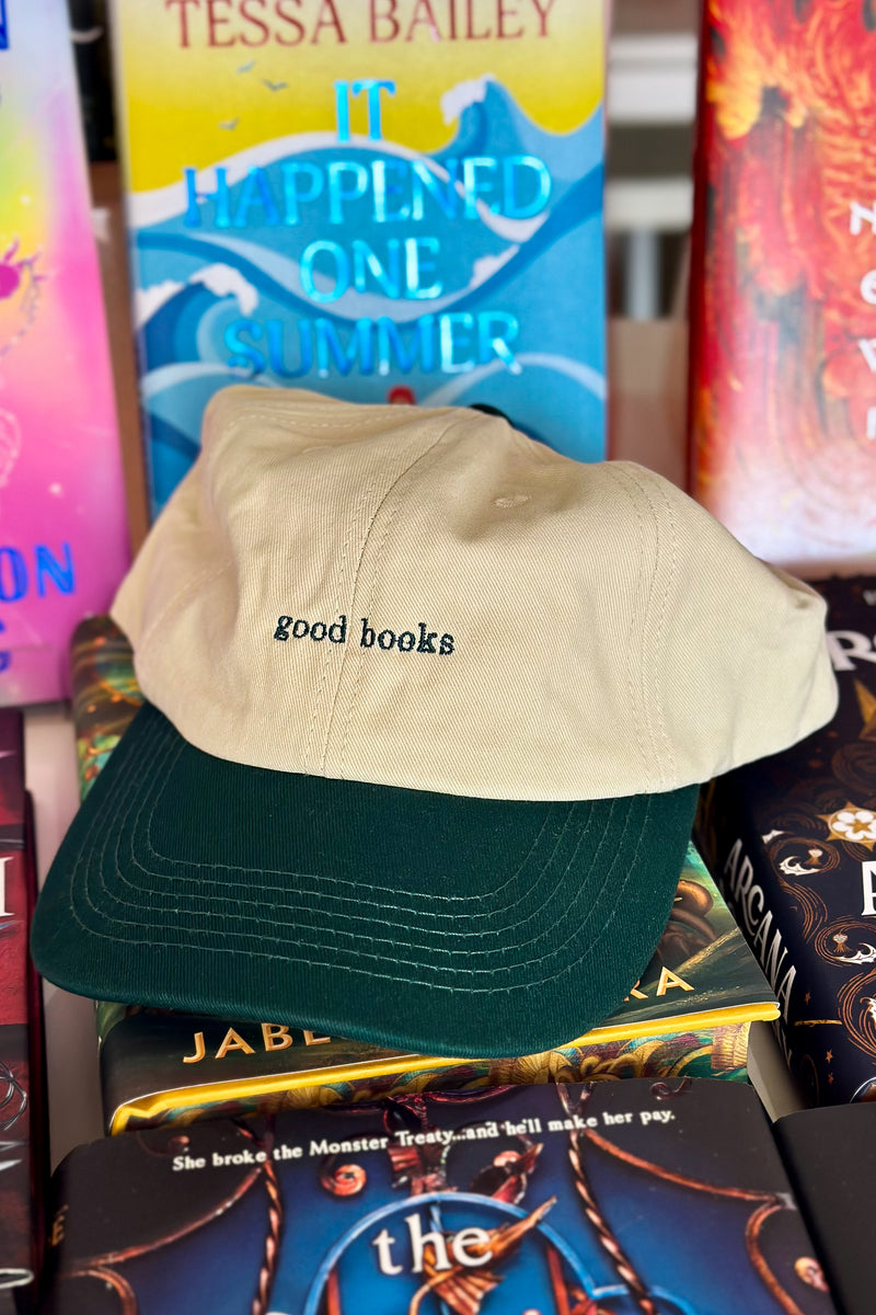 Beige and green cap with 'good books' text on top of books