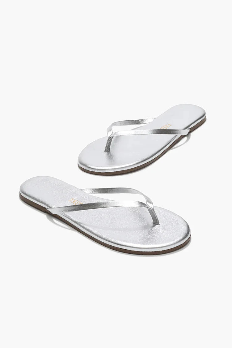 Silver flip-flops on a white background