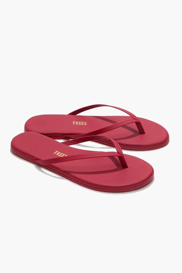Red flip-flops with a brand logo on a white background