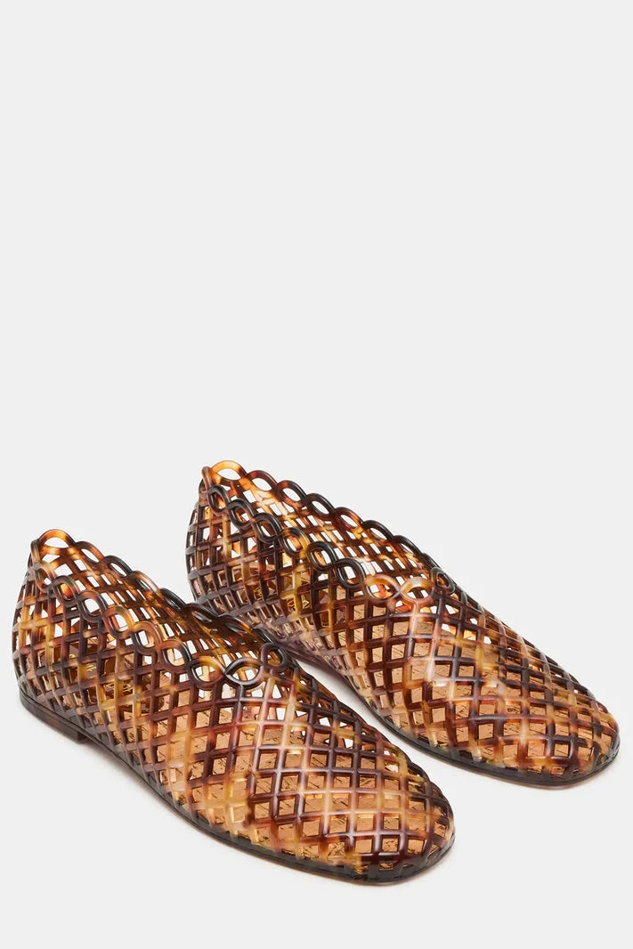 Pair of woven brown shoes on a light gray background
