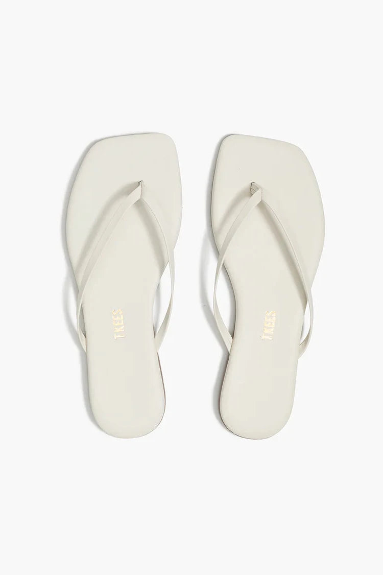 Pair of white flip-flops on a white background