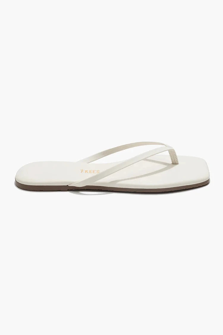 Cream sandals against a white background