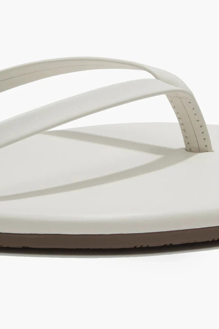 Cream sandals against a white background