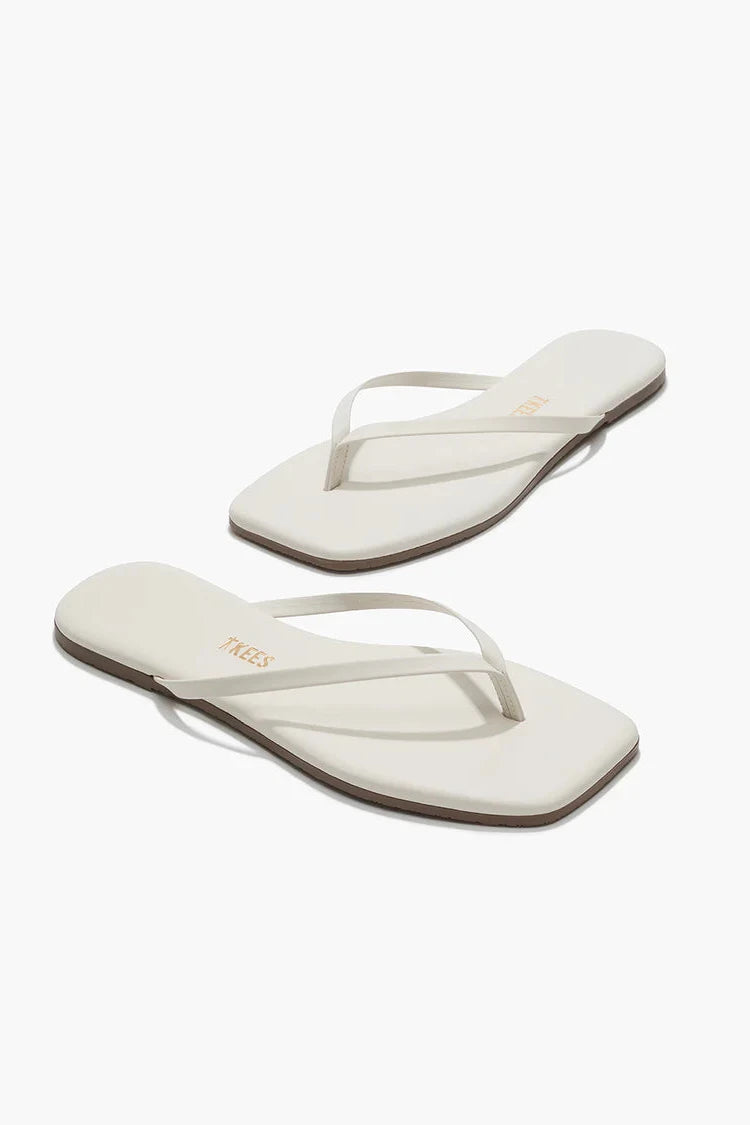 Cream sandals against a white background