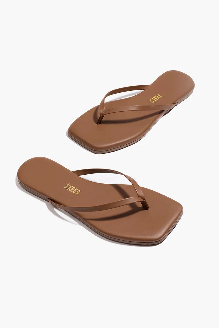 Pair of brown flip-flops on a white background