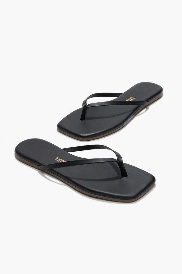 Pair of brown flip-flops on a white background
