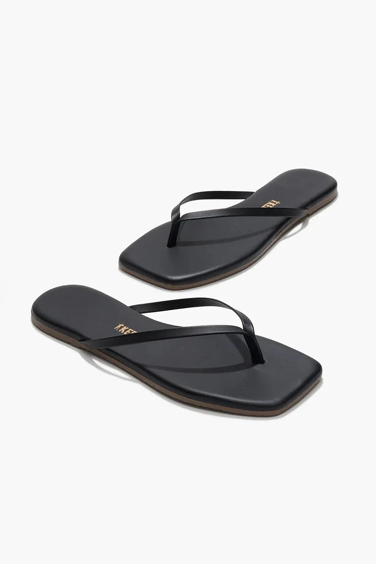 Black sandals against a white background