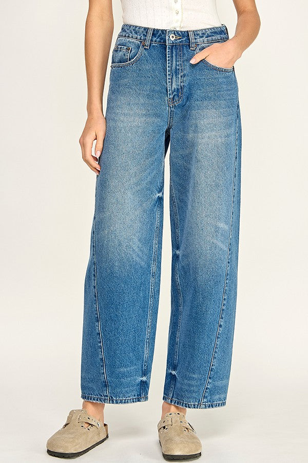 Person wearing blue jeans on a white background