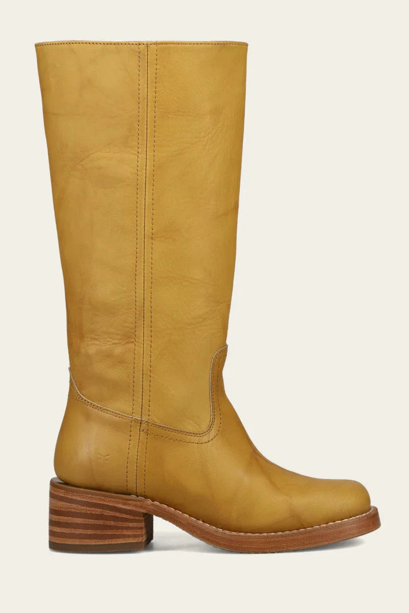 Tan knee-high boot with a wooden heel on a light gray background