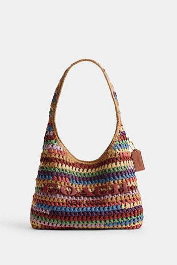Colorful woven bag labeled "COACH" on a white background