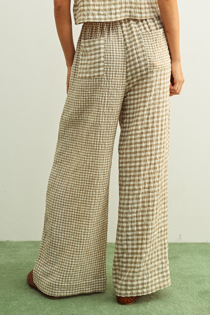 Person wearing plaid pants on a plain background